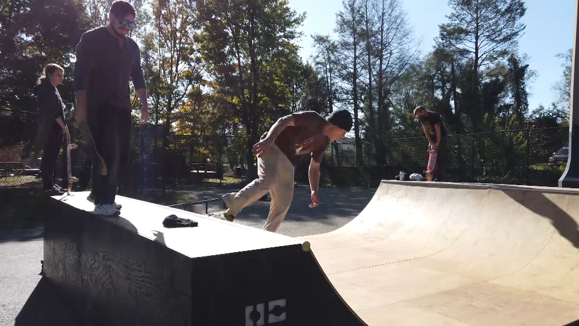 Skateboarders on halfpipe doing tricks