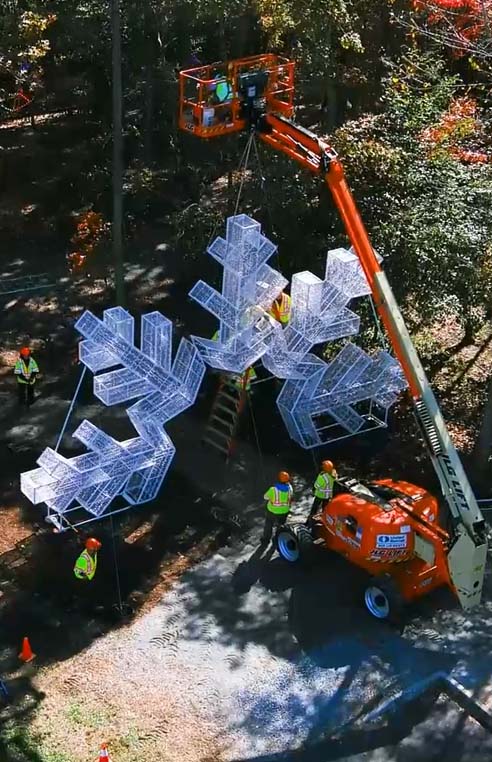 Aerial view of large snowflake archway being assembled.