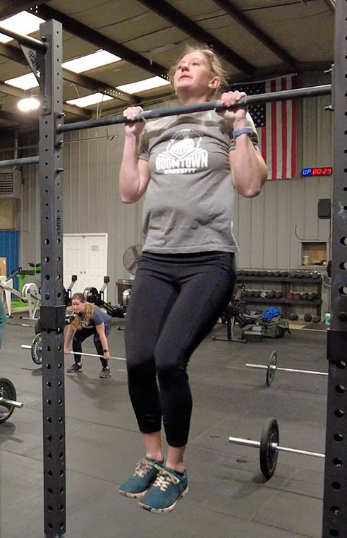 Woman doing pull-ups.